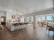 Modern white kitchen with an island, bar seating, and open sightlines to the dining area at 25 Cunningham Dr, New Smyrna Beach, FL 32168
