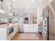 Kitchen with white cabinets, stainless steel appliances, and a view of the living area at 25 Cunningham Dr, New Smyrna Beach, FL 32168
