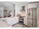 Modern kitchen featuring white cabinets, stainless steel appliances, and a farmhouse sink at 25 Cunningham Dr, New Smyrna Beach, FL 32168