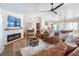 Cozy living room with leather furniture, a fireplace, and open kitchen access at 25 Cunningham Dr, New Smyrna Beach, FL 32168