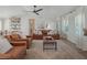 Living room with leather couches, decorative rug, and stylish decor at 25 Cunningham Dr, New Smyrna Beach, FL 32168