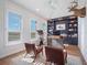 Home office with blue built-in shelves, leather chairs, and exercise bike at 25 Cunningham Dr, New Smyrna Beach, FL 32168