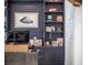 Close-up of a home office with built-in shelves, artwork, and personal touches at 25 Cunningham Dr, New Smyrna Beach, FL 32168
