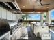 Stainless steel outdoor kitchen with grill, prep area, and a view at 25 Cunningham Dr, New Smyrna Beach, FL 32168