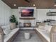 Outdoor living room with fireplace, comfortable seating, and a view of the kitchen at 25 Cunningham Dr, New Smyrna Beach, FL 32168