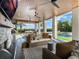 Covered outdoor space with comfortable seating, fireplace, TV, and pool view at 25 Cunningham Dr, New Smyrna Beach, FL 32168