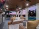 Relaxing outdoor space with fireplace, wicker furniture, and pool view at 25 Cunningham Dr, New Smyrna Beach, FL 32168
