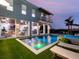 Resort-style backyard with pool, spa, and outdoor kitchen and fireplace at 25 Cunningham Dr, New Smyrna Beach, FL 32168