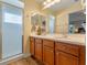 Bathroom with double vanity and walk-in shower at 28023 Cypress Springs Loop, Okahumpka, FL 34762