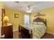 Bedroom with wood furniture and ceiling fan at 28023 Cypress Springs Loop, Okahumpka, FL 34762