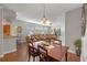 Open concept dining area with hardwood floors and a wooden table at 28023 Cypress Springs Loop, Okahumpka, FL 34762