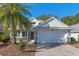 Charming single-story house featuring a two-car garage and well-maintained landscaping at 28023 Cypress Springs Loop, Okahumpka, FL 34762
