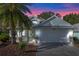 Attractive single-story home with a two-car garage and landscaped yard at 28023 Cypress Springs Loop, Okahumpka, FL 34762