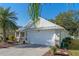 Single story home with a white garage door and metal roof at 28023 Cypress Springs Loop, Okahumpka, FL 34762