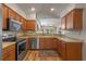 Kitchen with island, stainless steel appliances, and view of living room at 28023 Cypress Springs Loop, Okahumpka, FL 34762