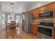 Modern kitchen with stainless steel appliances and wood cabinets at 28023 Cypress Springs Loop, Okahumpka, FL 34762