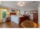 Spacious main bedroom with wood furniture and ceiling fan at 28023 Cypress Springs Loop, Okahumpka, FL 34762