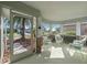 Bright and airy sunroom with white wicker furniture at 28023 Cypress Springs Loop, Okahumpka, FL 34762
