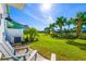 Private backyard with patio seating, lush lawn, and tropical landscaping at 2956 Caribbean Soul Dr, Kissimmee, FL 34747