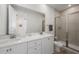 Modern bathroom with double vanities, a walk-in shower, and tiled walls at 2956 Caribbean Soul Dr, Kissimmee, FL 34747