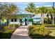 Entrance to the community beach club with palm trees and landscaping at 2956 Caribbean Soul Dr, Kissimmee, FL 34747