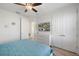 Inviting bedroom with a ceiling fan, TV, and double doors at 2956 Caribbean Soul Dr, Kissimmee, FL 34747