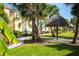Thatched-roof cabana and lush landscaping create a relaxing outdoor space at 2956 Caribbean Soul Dr, Kissimmee, FL 34747