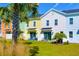 Row of townhouses with private patios and lush landscaping at 2956 Caribbean Soul Dr, Kissimmee, FL 34747