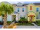 Colorful townhomes with tropical landscaping and inviting entryways at 2956 Caribbean Soul Dr, Kissimmee, FL 34747