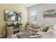 Living room corner with comfortable seating, entertainment center, and decor at 2956 Caribbean Soul Dr, Kissimmee, FL 34747
