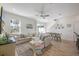Living room with sectional sofa, coastal decor, and wood-look tile flooring at 2956 Caribbean Soul Dr, Kissimmee, FL 34747