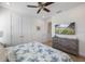 Main bedroom with a king-size bed, ceiling fan, walk-in closet, and a dresser at 2956 Caribbean Soul Dr, Kissimmee, FL 34747