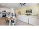 Open concept living and dining area with kitchen, wood-look tile, and coastal decor at 2956 Caribbean Soul Dr, Kissimmee, FL 34747