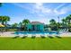 Community pool with lounge chairs, restrooms, and lush synthetic turf at 2956 Caribbean Soul Dr, Kissimmee, FL 34747