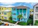 Two-story light blue house with green accents, located in a vibrant community at 3056 Parrot Head Pl, Kissimmee, FL 34747