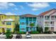 Two-story light blue house with green accents, located in a vibrant community at 3056 Parrot Head Pl, Kissimmee, FL 34747