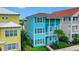 Two-story light blue house with green accents, located in a vibrant community at 3056 Parrot Head Pl, Kissimmee, FL 34747