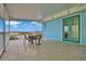 Covered balcony with outdoor seating and water views at 3056 Parrot Head Pl, Kissimmee, FL 34747