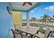 Covered balcony with table and chairs, overlooking a lake at 3056 Parrot Head Pl, Kissimmee, FL 34747