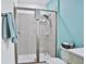 Walk-in shower with neutral tile and light blue walls at 3056 Parrot Head Pl, Kissimmee, FL 34747