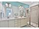 Double vanity bathroom with a walk-in shower at 3056 Parrot Head Pl, Kissimmee, FL 34747