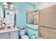 Bathroom with walk-in shower, grab bars, and modern vanity at 3056 Parrot Head Pl, Kissimmee, FL 34747