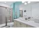 Bathroom with shower, vanity, and bright teal walls at 3056 Parrot Head Pl, Kissimmee, FL 34747