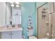 Bathroom with teal walls and a walk-in shower at 3056 Parrot Head Pl, Kissimmee, FL 34747