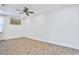 Bright bedroom with ceiling fan and wood-look tile floor at 3056 Parrot Head Pl, Kissimmee, FL 34747