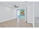 Spacious bedroom with ceiling fan and access to another room at 3056 Parrot Head Pl, Kissimmee, FL 34747