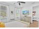 Bedroom with mounted TV, dresser, and access to a small den at 3056 Parrot Head Pl, Kissimmee, FL 34747