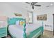 Main bedroom with teal bed frame and large TV at 3056 Parrot Head Pl, Kissimmee, FL 34747