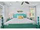 Main bedroom with teal bed frame and ocean decor at 3056 Parrot Head Pl, Kissimmee, FL 34747
