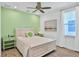 Bedroom with white bed frame and light green walls at 3056 Parrot Head Pl, Kissimmee, FL 34747